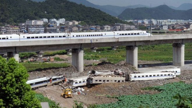 A high-speed train runs past the accident site of the earlier collision of two trains on July 24, 2011 in Wenzhou, Zhejiang Province of China