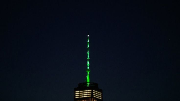 One World Trade Center in New York was one of a number of buildings around the world lit up in green in protest at Mr Trump's move
