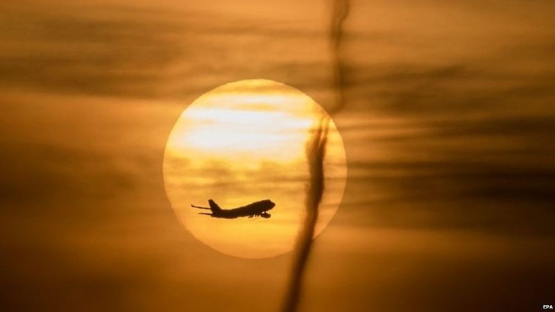 Airplane against a setting sun