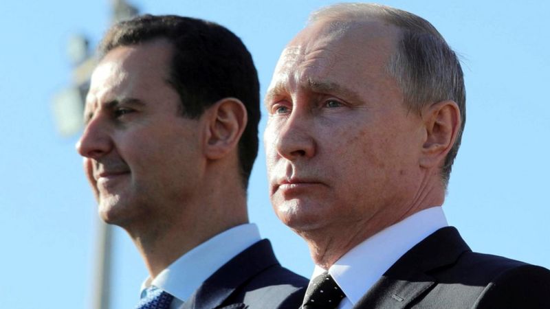 Russian President Vladimir Putin (R) and Syrian President Bashar al-Assad visit the Hmeymim air base in Latakia Province, Syria, 11 December 2017