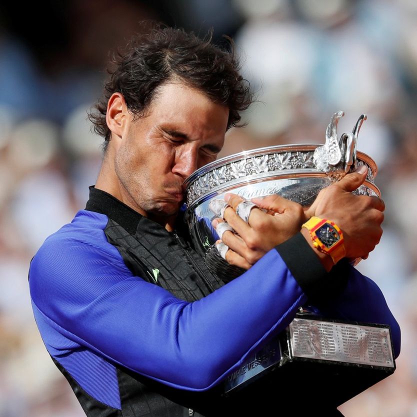Spain's Rafael Nadal celebrates with the trophy after winning the final against Switzerland's Stan Wawrinka