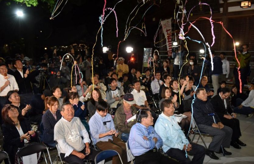Fans of Japanese novelist Haruki Murakami react when the Swedish Academy awarded the Nobel prize for literature to Japanese-born British novelist Kazuo Ishiguro at a shrine in Tokyo on 5 October 2017.