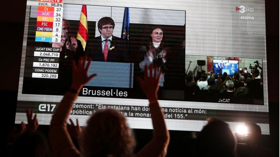 People watch Carles Puigdemont after Catalonia's regional election in Brussels, on a giant screen in Barcelona, Spain, December 21, 2017