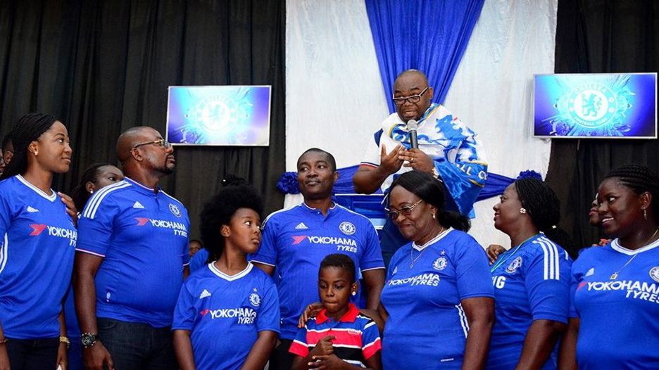 Pastor with his congregants in Chelsea shirts