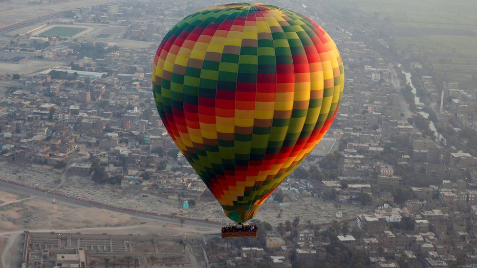A hot-air balloon flies over the city of Luxor, south of Cairo, Egypt December 13, 2016.