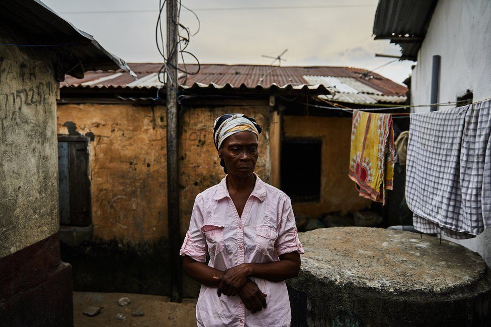 Eva Nah pictured outside her house in West Point, Monrovia, Liberia.