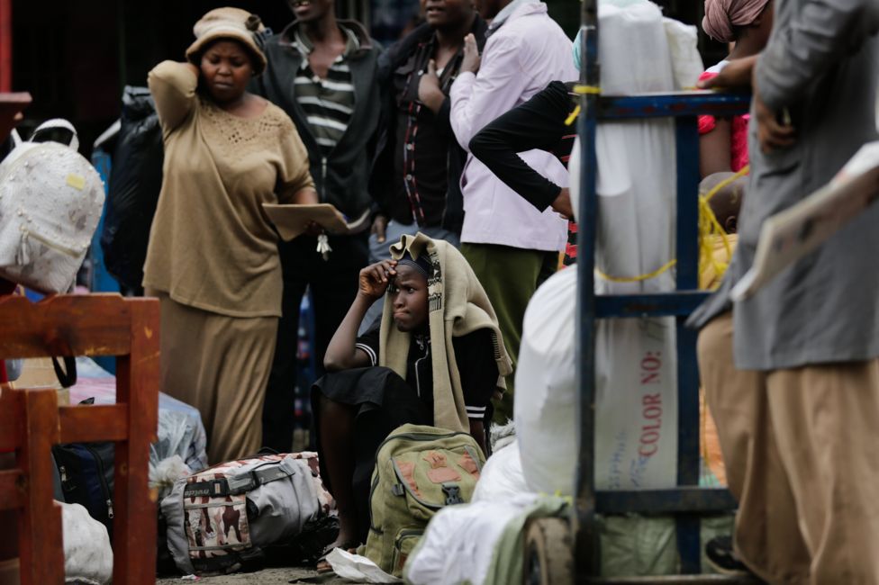 Kenyans wait in central Nairobi for buses to arrive to take them to rural homes ahead of next week's general election