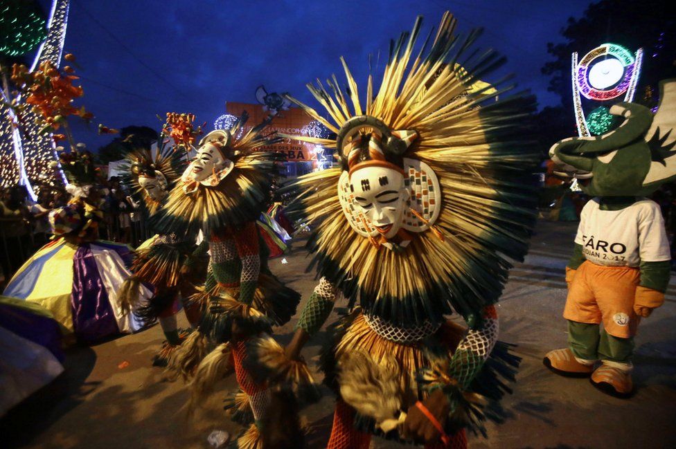 Dancers in costumes perform at a festival