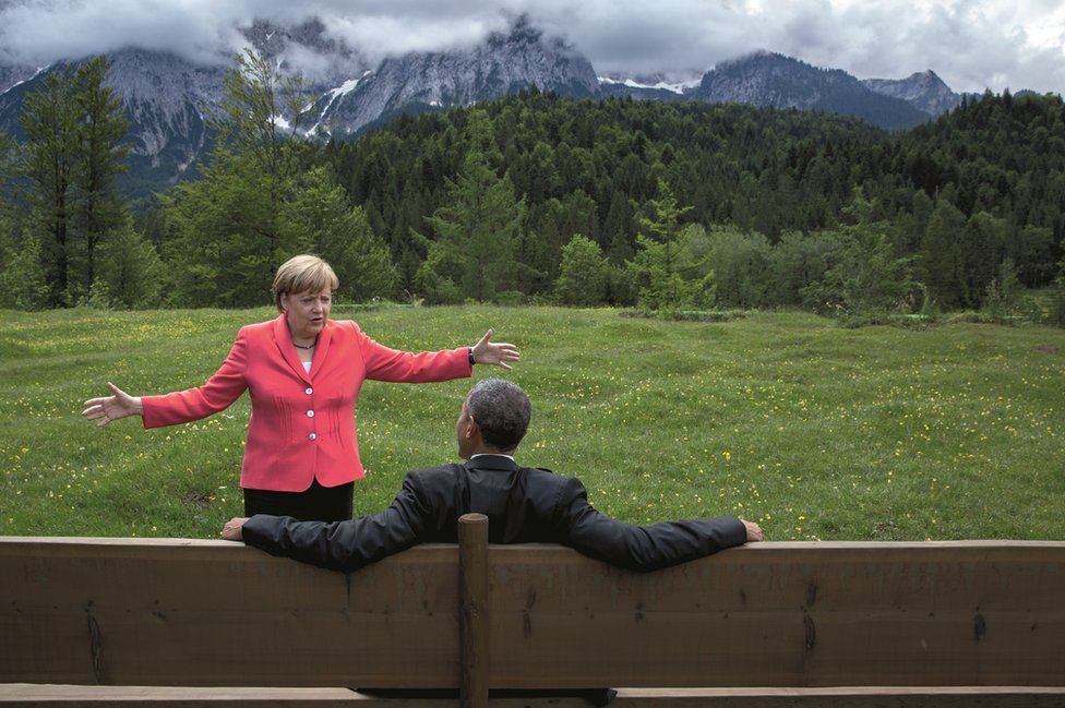 Angela Merkel gestures to Obama