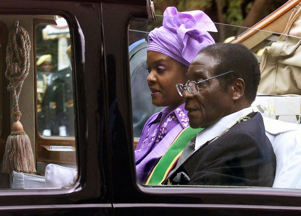President Robert Mugabe and his wife Grace leave parliament in their ceremonial car after its official opening, Harare - 22 July 2003