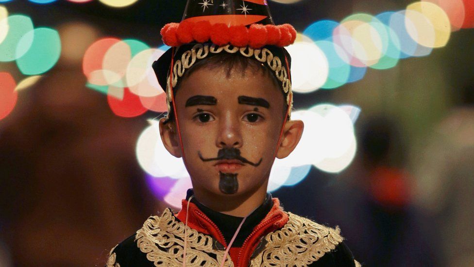 A boy wearing a folk costume takes part in a procession celebrating the religious holiday of Mawlid al-Nabi, the birthday of Prophet Mohammad, in Benghazi, Libya December 10, 2016