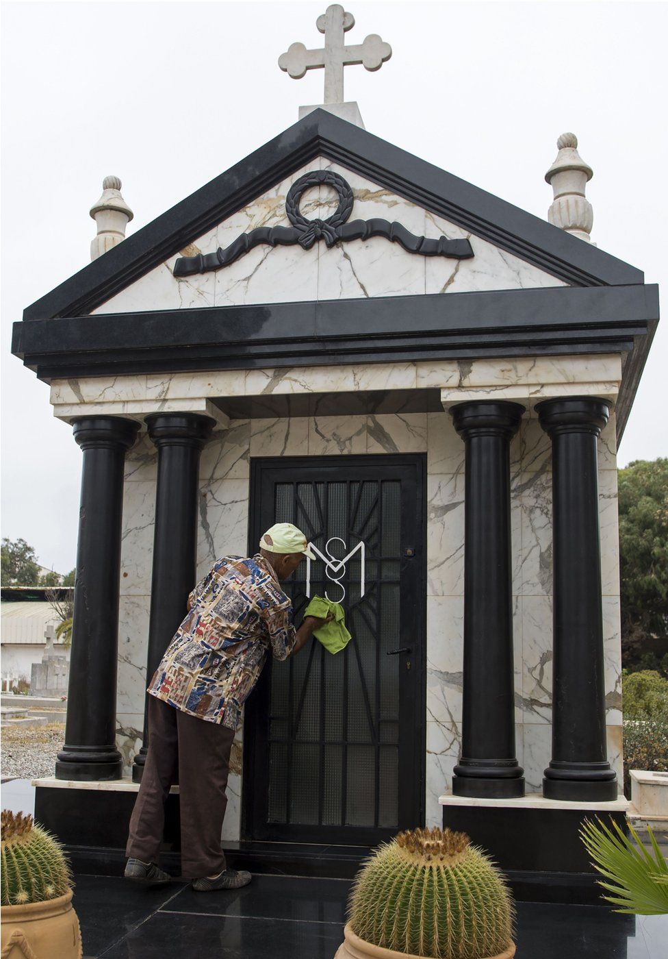 A man cleans the tomb of Mobutu Sese Seko, the late dictator of the self-styled "King of Zaire", which was later renamed the Democratic Republic of Congo after his overthrow, in the European cemetery in Rabat on September 3, 2017, four days before the 20th anniversary of his death. Mobutu died on September 7, 1997 at the Mohamed V military hospital in Rabat after a long battle with prostate cancer. Twenty years on from his death in exile in Morocco, the simple initials MSS on a family grave mark the resting place of Mobutu Sese Seko, the self-styled "King of Zaire".