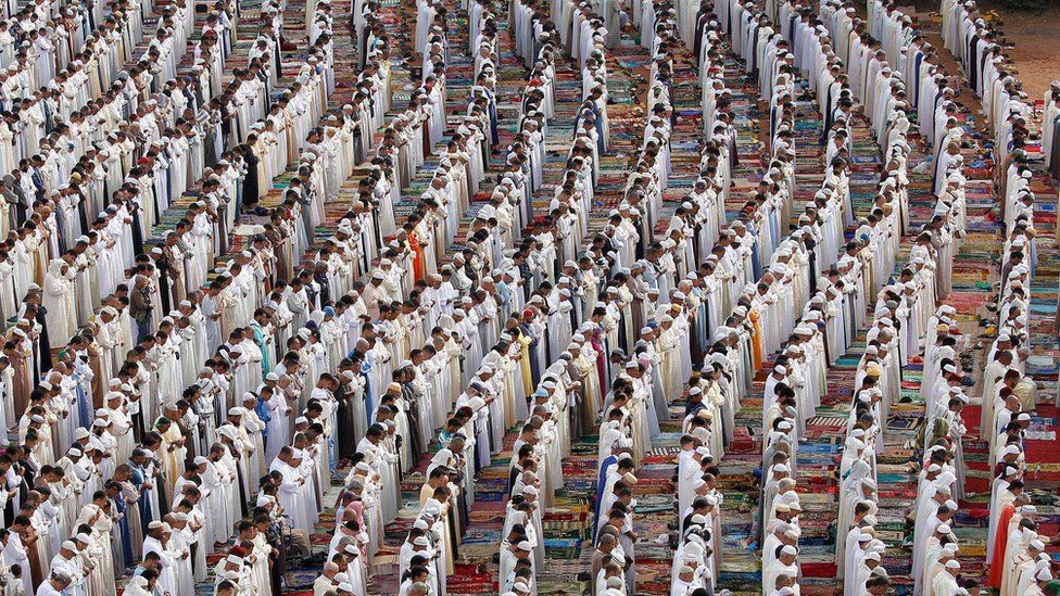 People attend Eid al-Fitr prayers to mark the end of the holy fasting month of Ramadan at a play ground in the suburb of Sale, Morocco June 26, 2017.