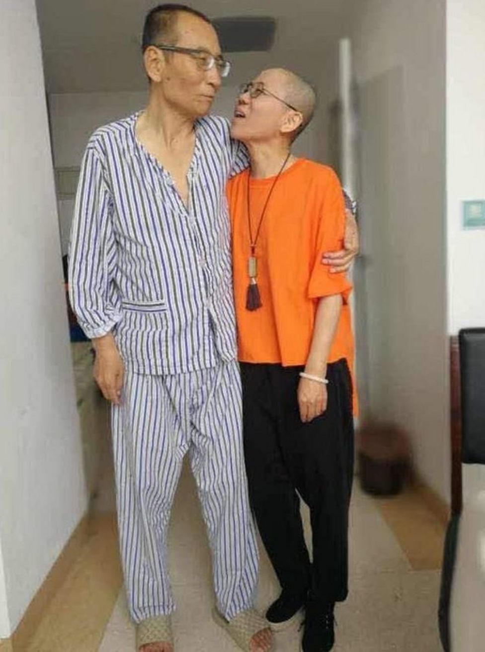 Liu Xiaobo and Liu Xia, he in pyjamas and she in outdoor clothes