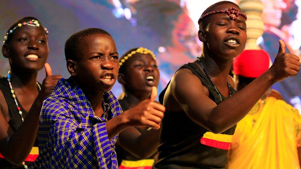 Young people living in Uganda as refugees perform a song during refugees solidarity summit held in Uganda"s capital Kampala June 23, 2017.