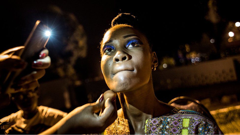 A Congolese fashion model is seen whilst she prepares her makeup backstage ahead of the Kinshasa Fashion Week on October 14, 2017 in Kinshasa.