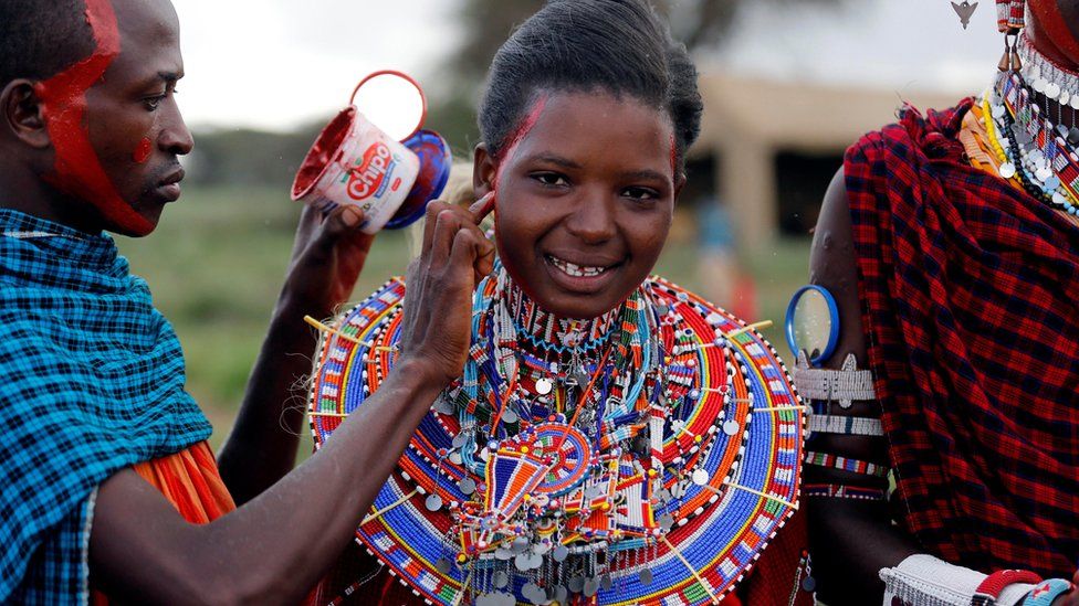 Joyce Tokoyan, a Maasai female athlete, has her face smeared with red ocher paint during preparations for the 2016 Maasai Olympics at the Sidai Oleng Wildlife Sanctuary, at the base of Mt. Kilimanjaro, near the Kenya-Tanzania border in Kimana, Kajiado, Kenya December 10, 2016.