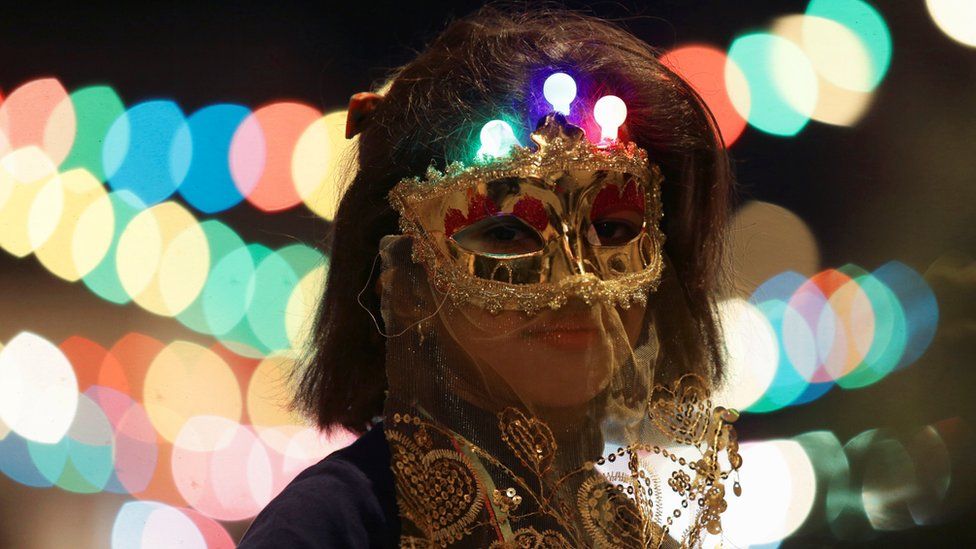 A girl wearing a mask takes part in a procession celebrating the religious holiday of Mawlid al-Nabi, the birthday of Prophet Mohammad, in Benghazi, Libya December 10, 2016. Picture taken December 10, 2016
