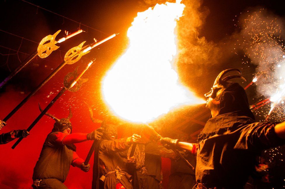 Revellers in costumes take part in the traditional "Correfoc" festival in Palma de Mallorca on 21 January 2018.