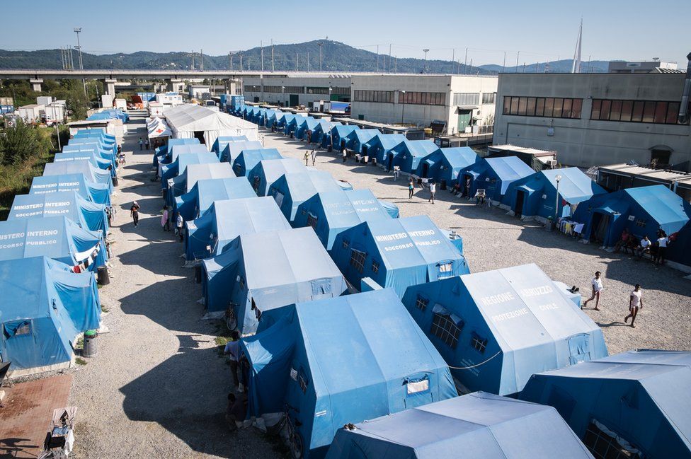 A row of blue tents photographed from above.