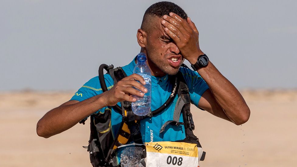 Morocco Mohamed el-Morabity, pours water on his face as he runs to win the first edition of the Ultra Mirage El Djerid marathon in the desert near the southwestern Tunisian city of Tozeur on October 7, 2017. The Ultra Mirage El Djerid marathon is a 100 kilometres ultra marathon across the largest salt pan of the Sahara Desert.