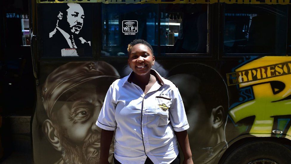 Annastacia Wainaina, 34, a crew-member in a matatu (a local word for privately owned public transport buses) poses as she waits in line to pick up passengers in Nairobi's central business district on February 26, 2018. Annastacia, who has been a matatu driver since 2005 plying along one of Nairobi's most densely populated routes in Kasarani, is one of only a few women drivers who are shattering an old stereotype that to make it as a matatu-crew, widely regarded as renegades, sexist and reckless, one has to be mal