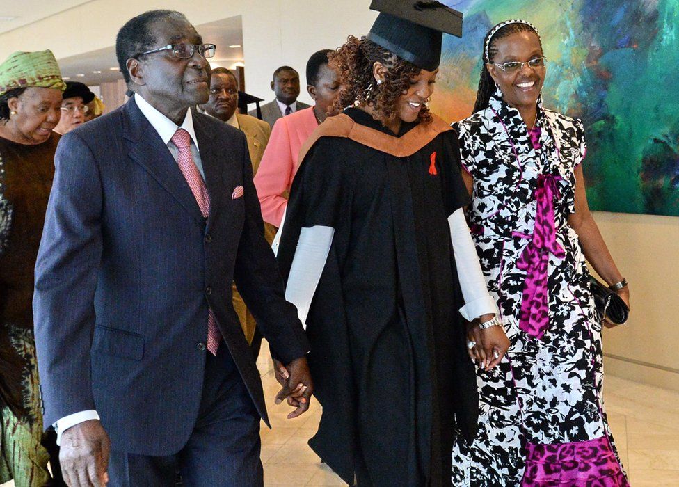 Zimbabwe's President Robert Mugabe (L) and his wife Grace (R) with first-born child and only daughter Bona Mugabe (C) leaving a graduation ceremony at MDIS-University of Wales graduation ceremony in Singapore - 16 November 2013