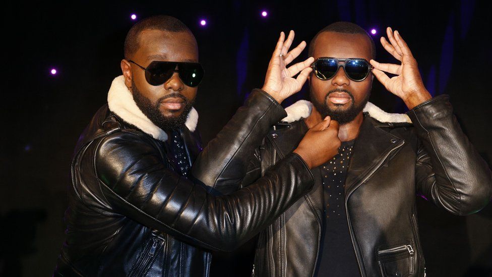 Maitre Gims (L) pulls the beard of his wax look alike at the Musee Grevin wax museum in Paris, France - Monday 2 October 2017