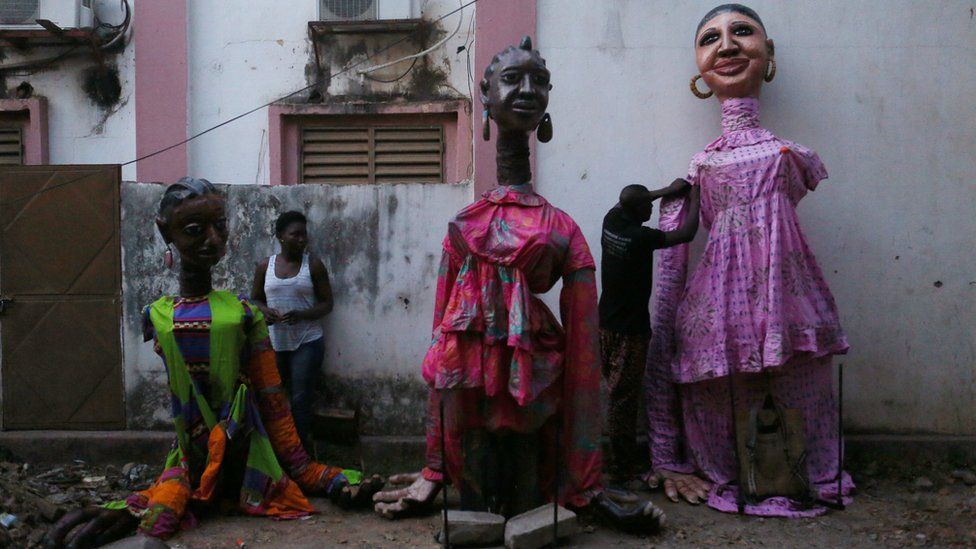 Dancers fix costumes after wearing them during a performance at the Musee du District in Bamako, Mali, December 9, 2016.