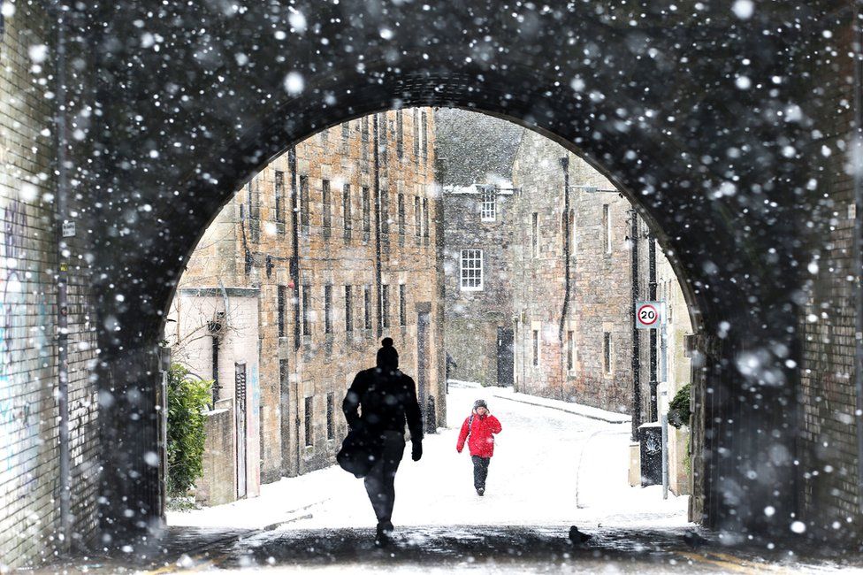 A view through the falling snow looking down the Croft-an-Righ in Holyrood, Edinburgh