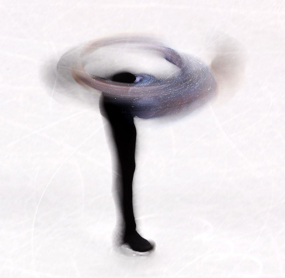 Adam Rippon spins on the ice