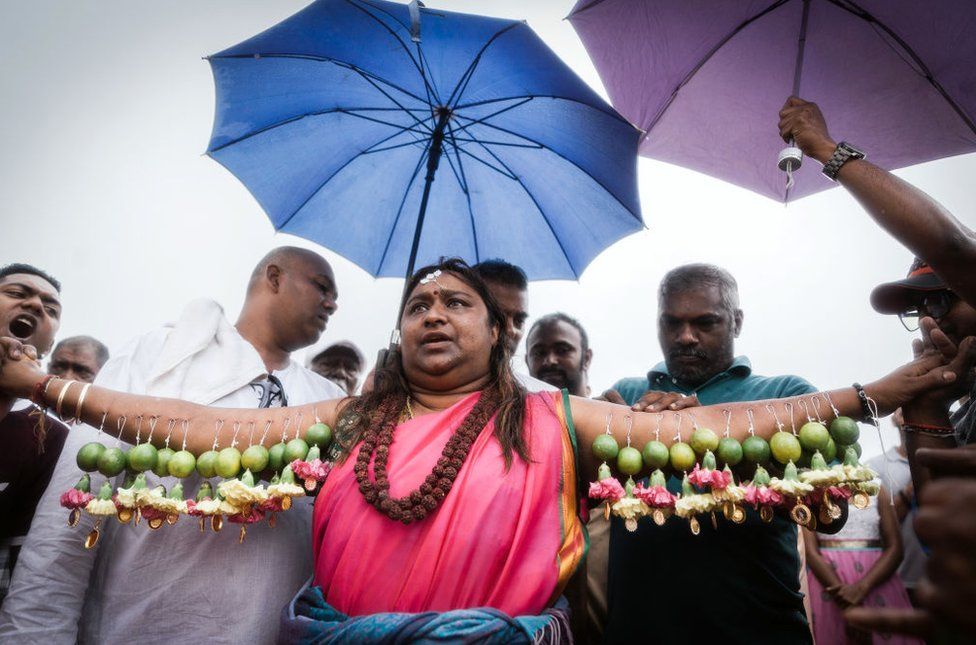 A Hindu devotee gets her body hooked with spikes, lime, coconuts,fruits and flowers during the annual Hindu Thaipoosam Kavady festival held at Shree Emperumal Hindu Temple in Mount Edgecombe township, some 42 kms north of Durban on February 3, 2018
