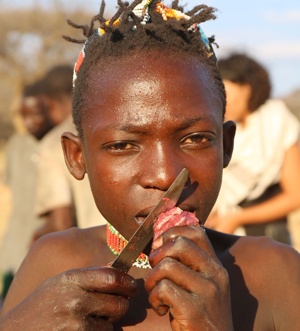 Hadza child eating red meat