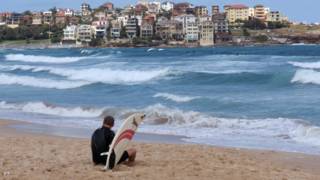 Surfer watches the waves