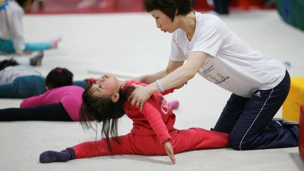 Representantes de la Escuela de Atletismo Amateur para Jóvenes de Shanghái Yangpu se pasean por los parvularios para promocionar la gimnasia entre padres y alumnos.